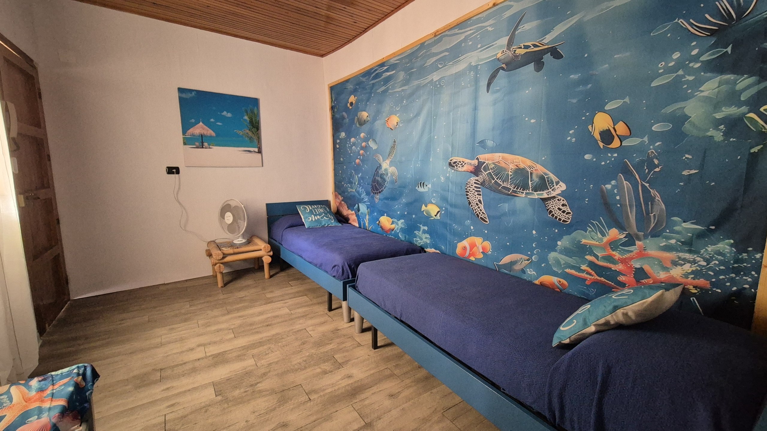 day52-cefalu-apartment-turtle-mural An underwater mural with sea turtles above the beds in the apartment