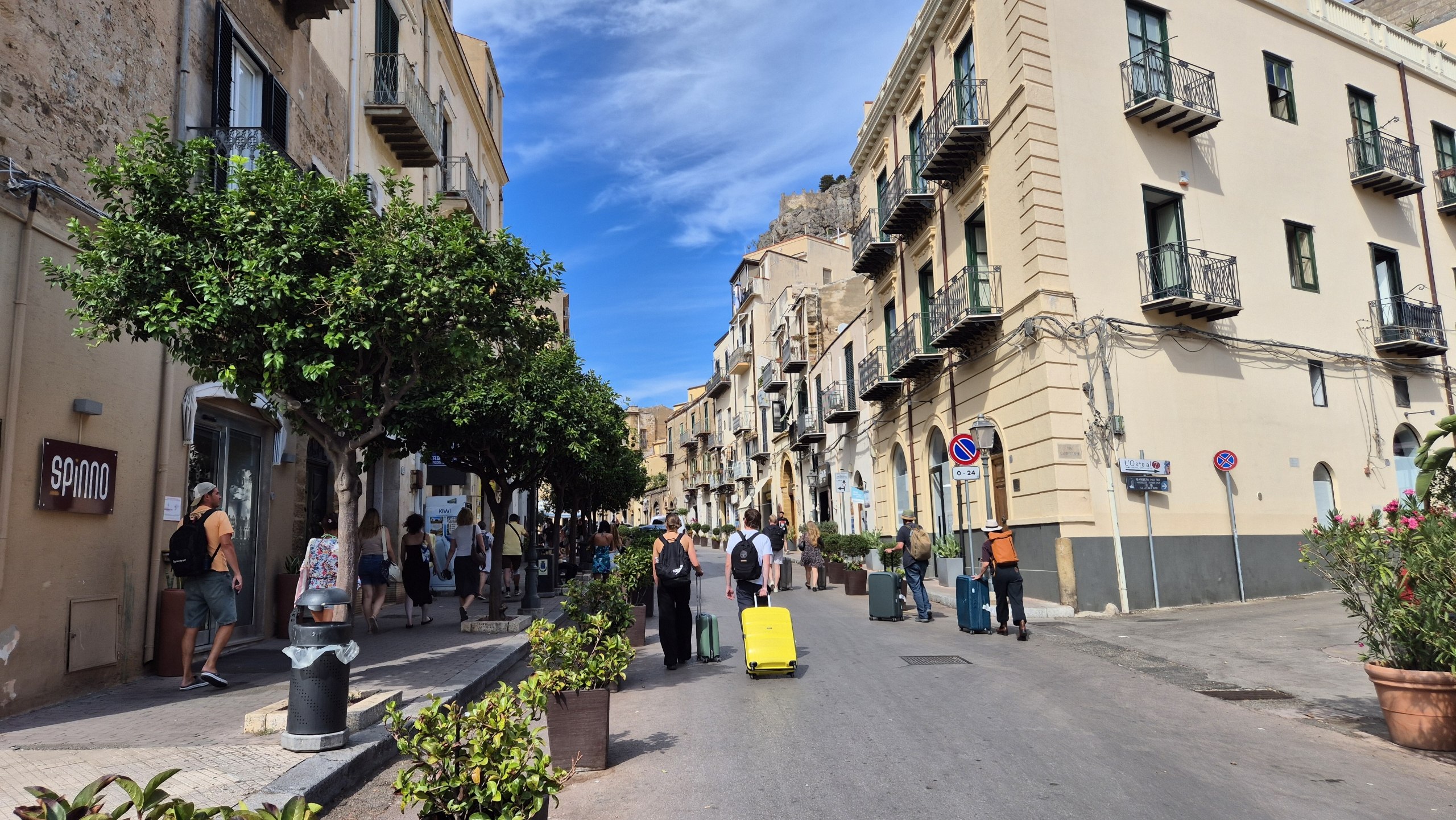 day52-cefalu-wheeled-suitcases Travellers pulling wheeled suitcases through the streets of Cefalù
