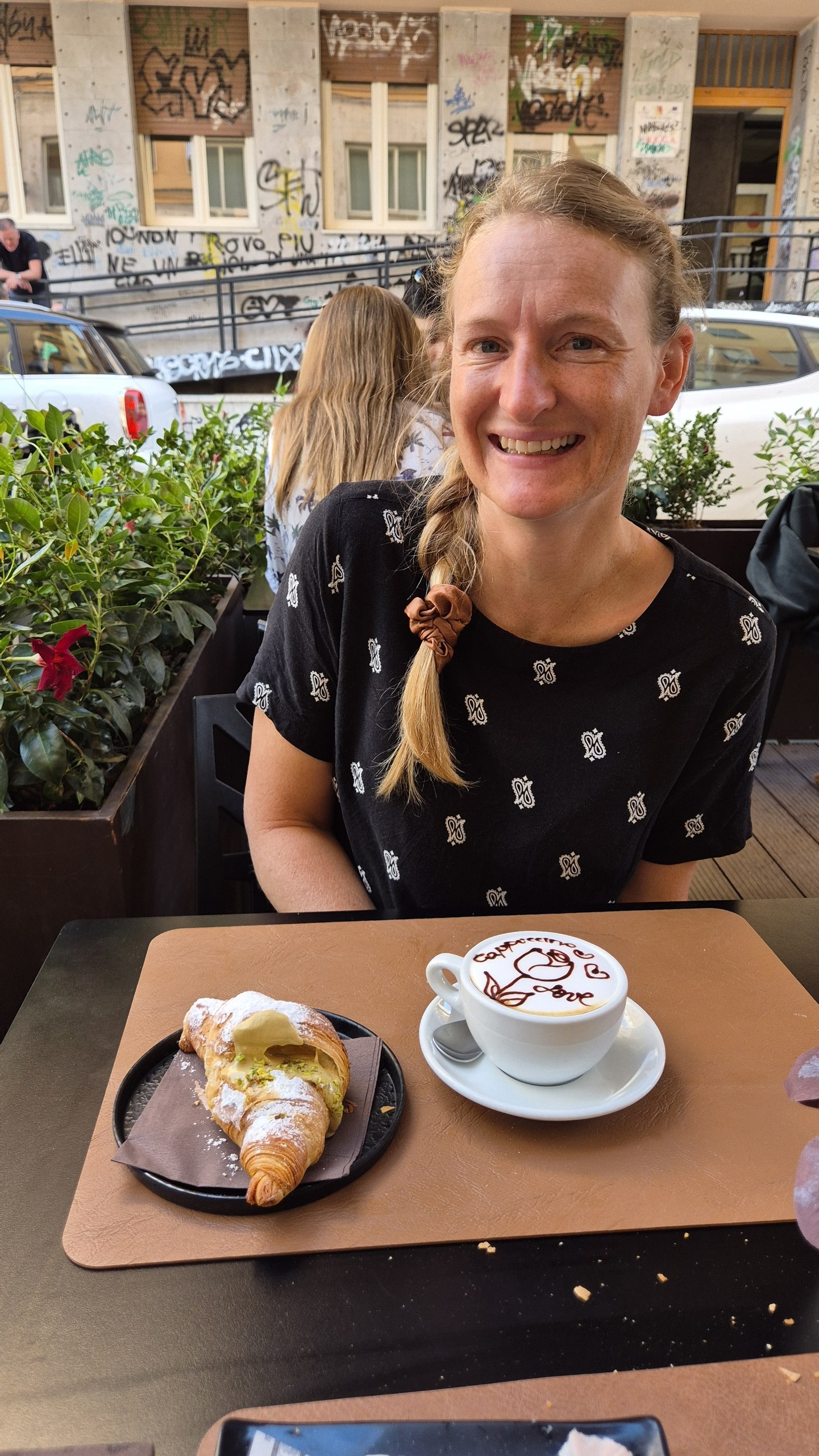 day52-palermo-cappuccino-croissant Caro with a cappuccino and pistachio croissant at a Palermo coffee shop