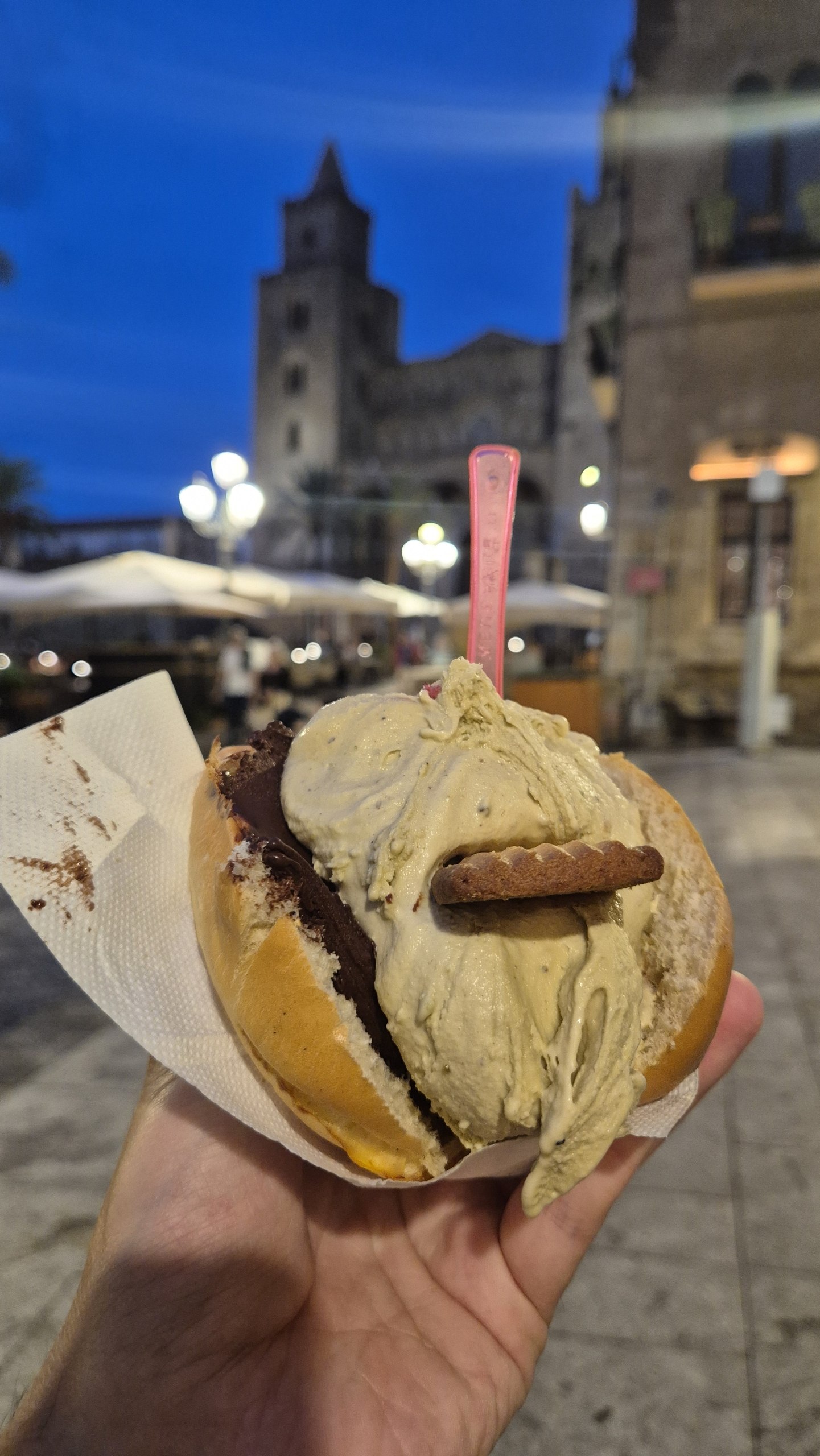 days53-54-cefalu-gelato-brioche A gelato brioche with dark chocolate and pistachio gelato in front of Cefalù Cathedral