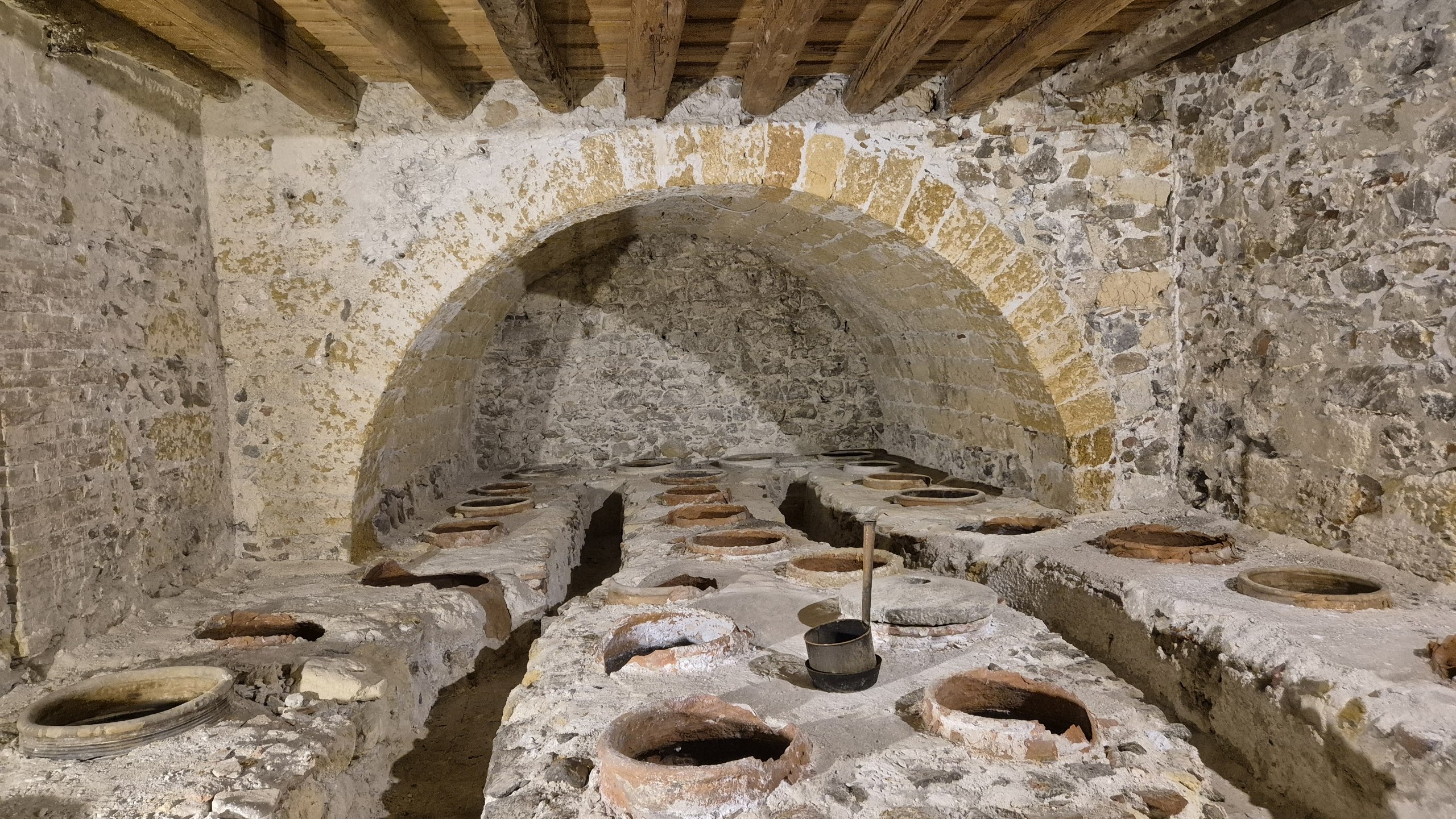 days53-54-mandralisca-oil-store Large storage jars sunk into the floor of the Mandralisca family oil store
