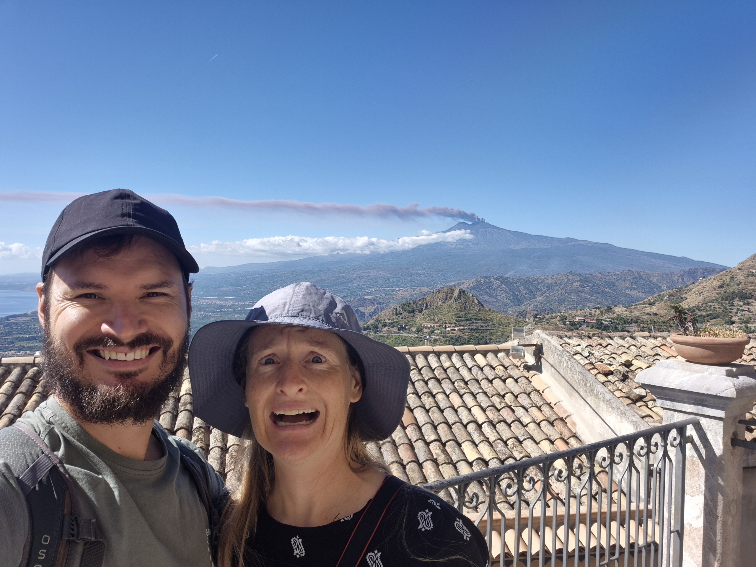 Hugo and Caro with Mount Etna and its long smoke column behind them
