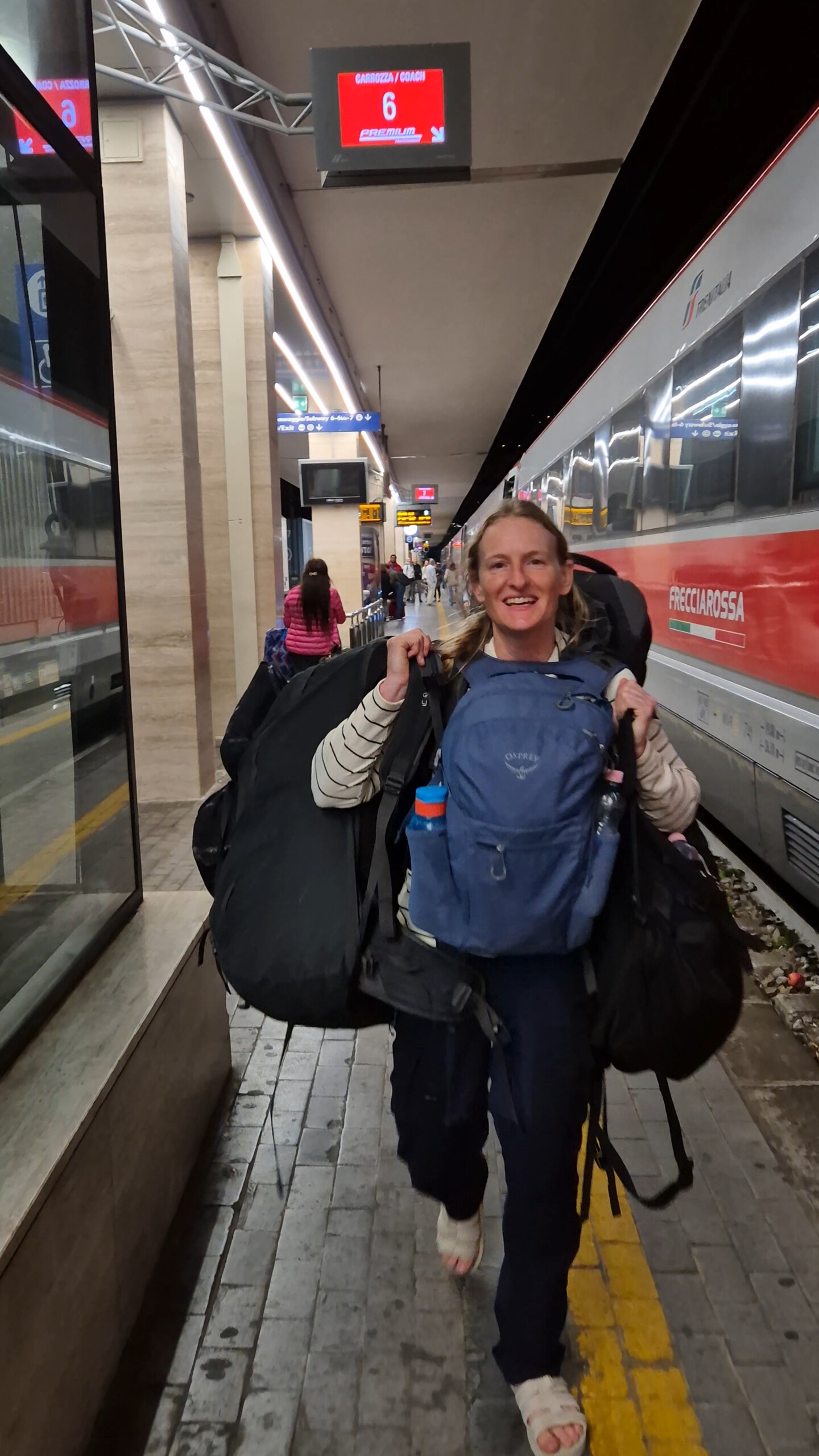 day60-caro-four-bags-salerno Caro carrying all four of our bags along the platform at Salerno