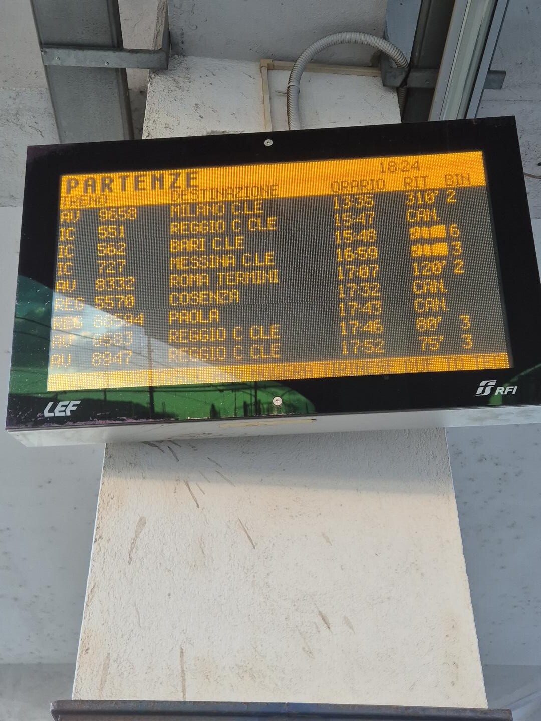 day60-lamezia-departures-chaos The departures board at Lamezia Terme showing delays up to 310 minutes and four cancellations