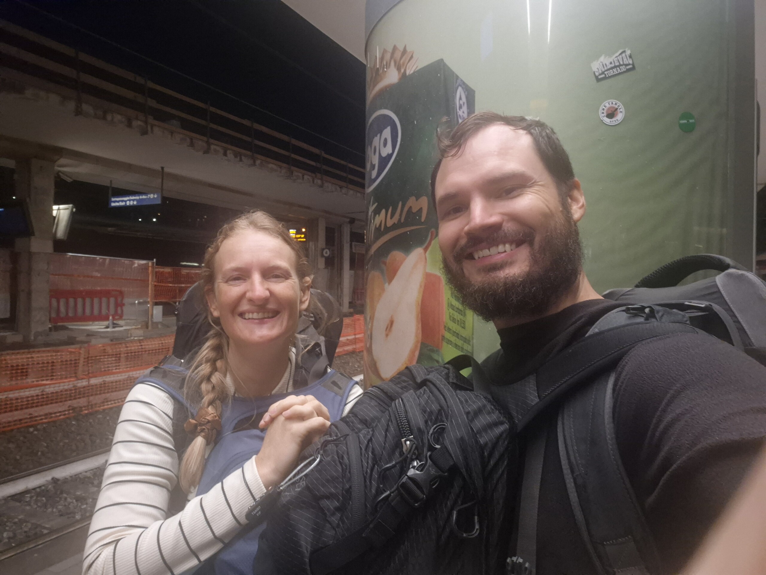 day60-reunited-salerno Hugo and Caro back together on the platform at Salerno, still wearing the packs