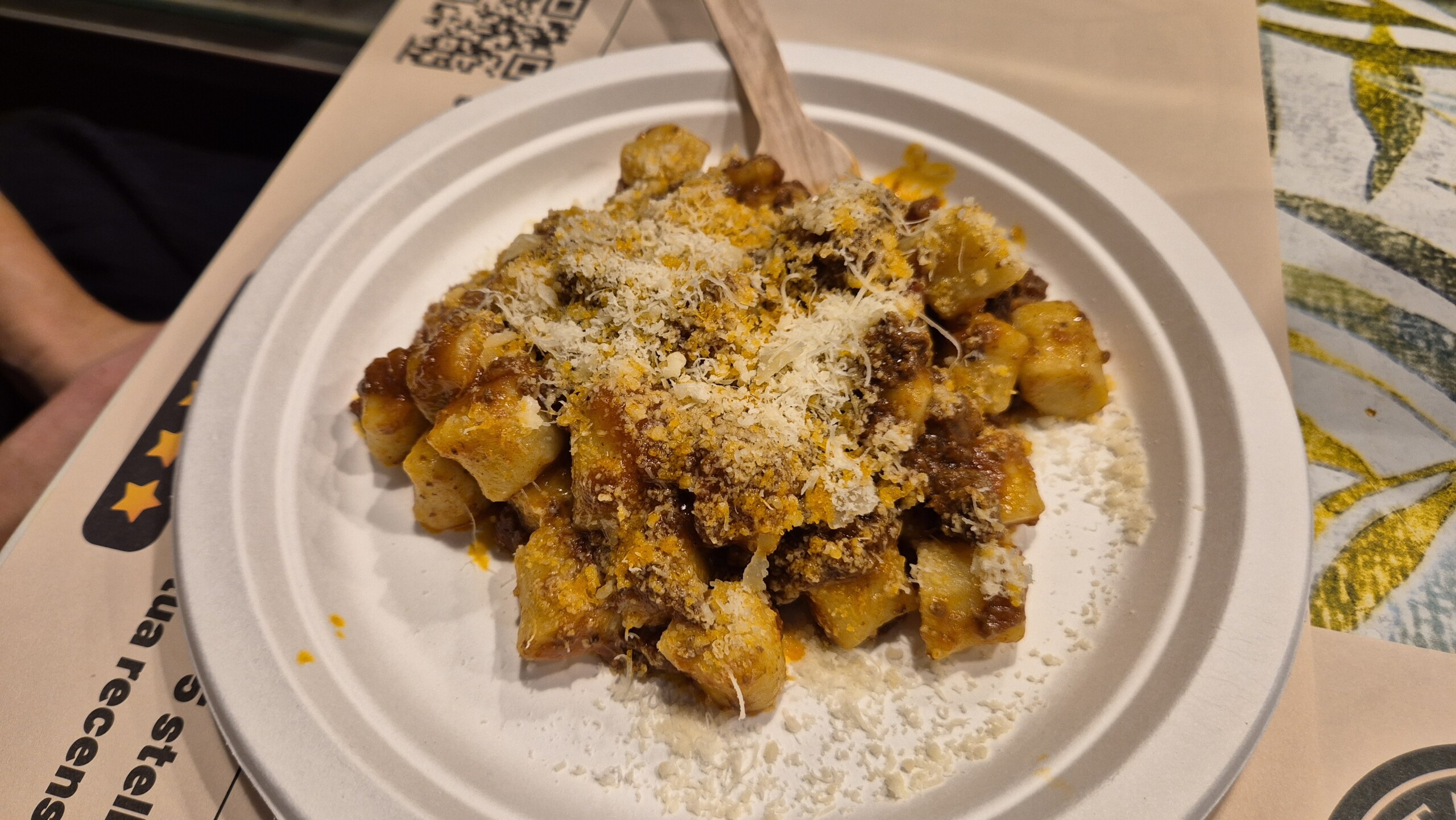 day64-gnocchi-bolognese-paper-plate Gnocchi with bolognese on a paper plate with a wooden fork