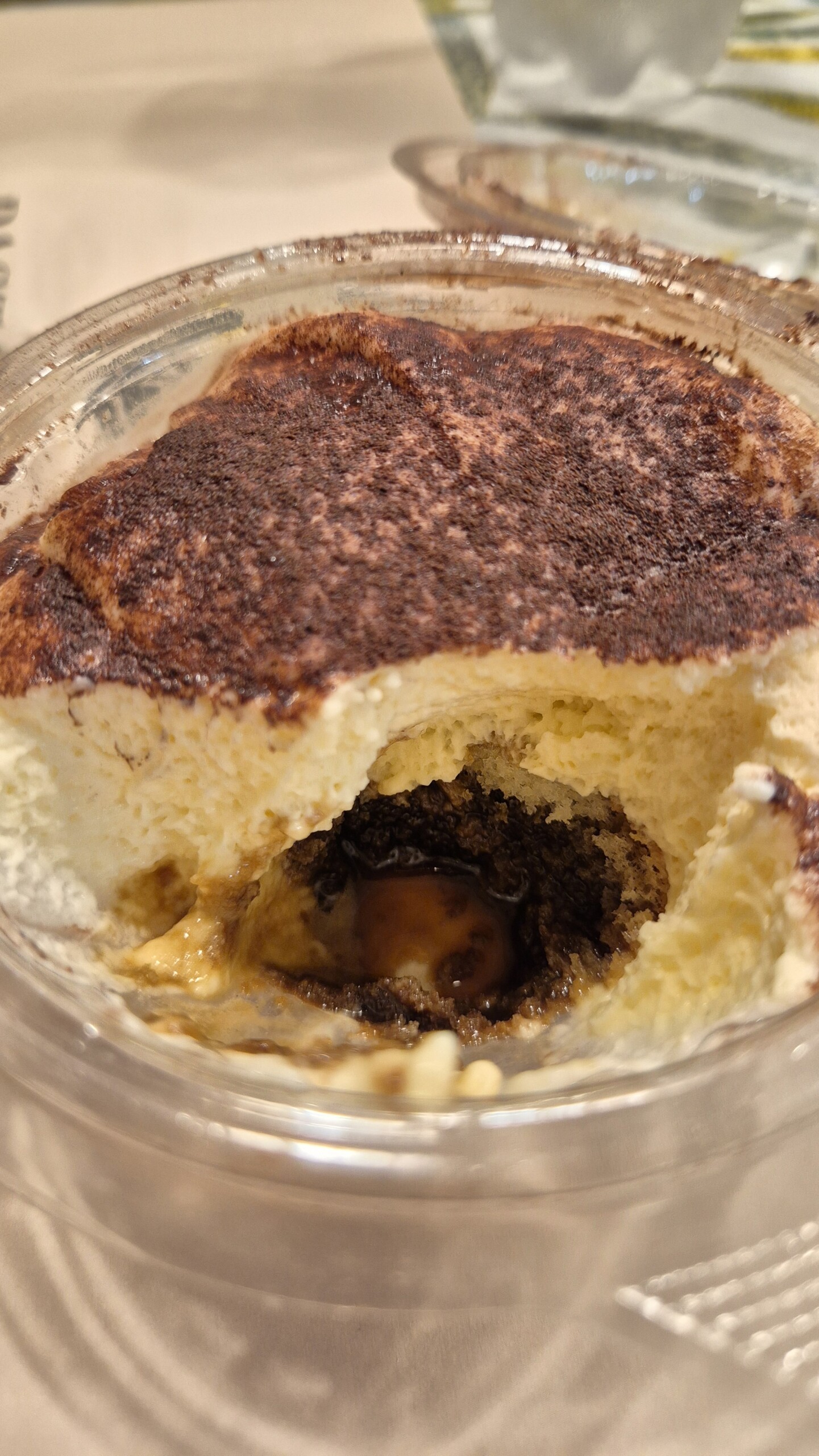 day64-tiramisu-tub A tiramisu in a plastic tub with the first spoonful taken out