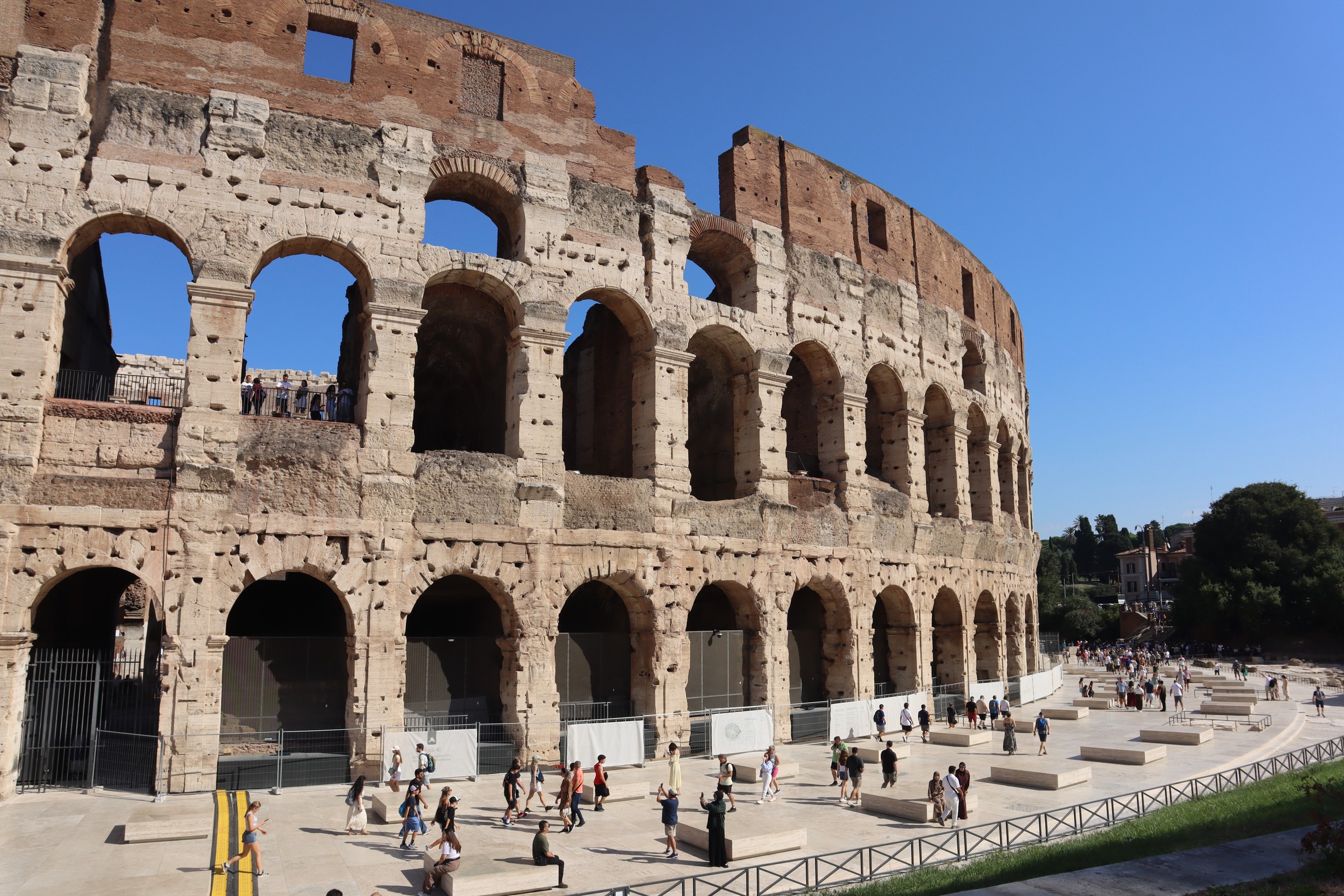 day65-colosseum-exterior The arched exterior of the Colosseum under a clear sky