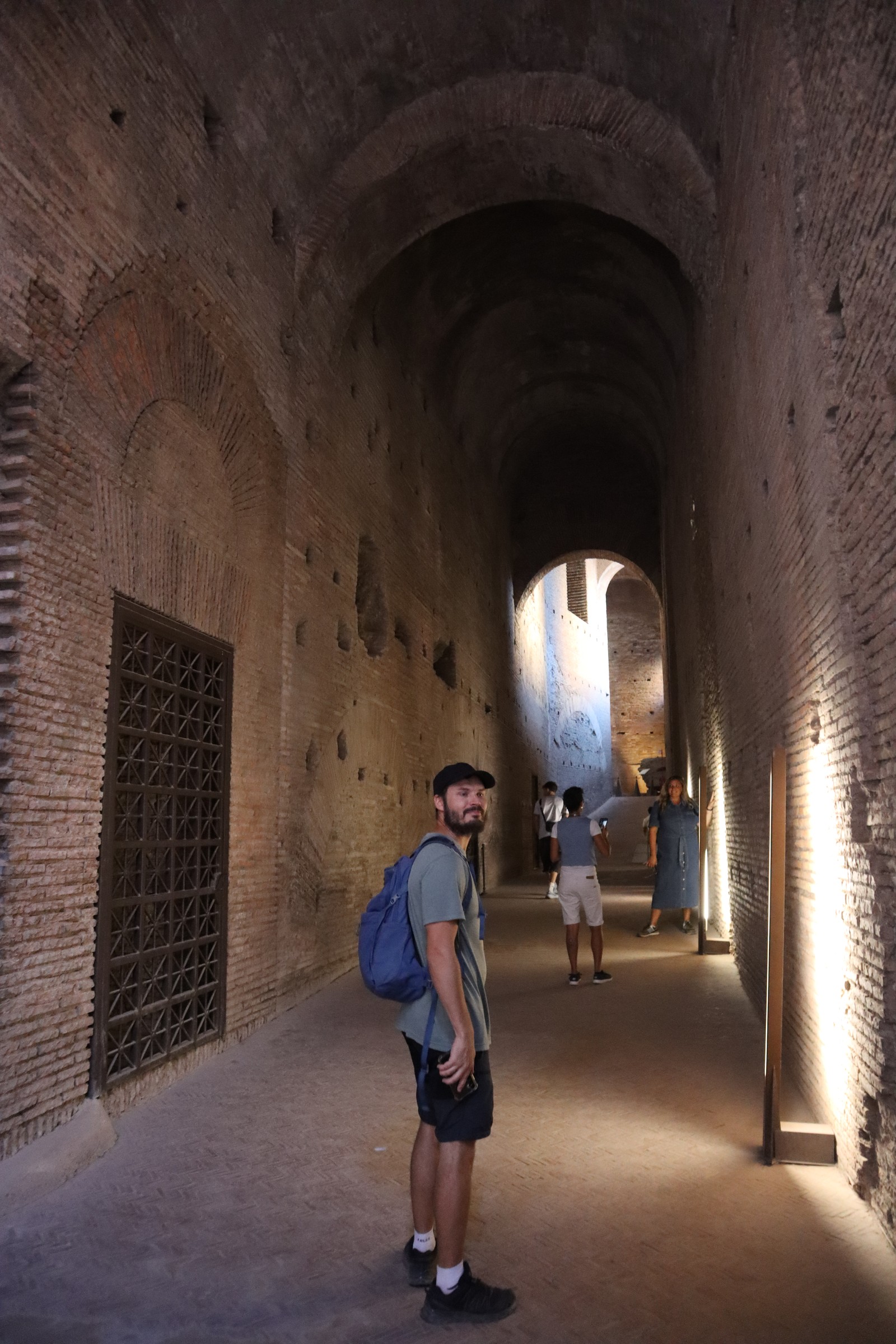 day66-forum-brick-passage Hugo standing in a tall brick passage in the Forum complex