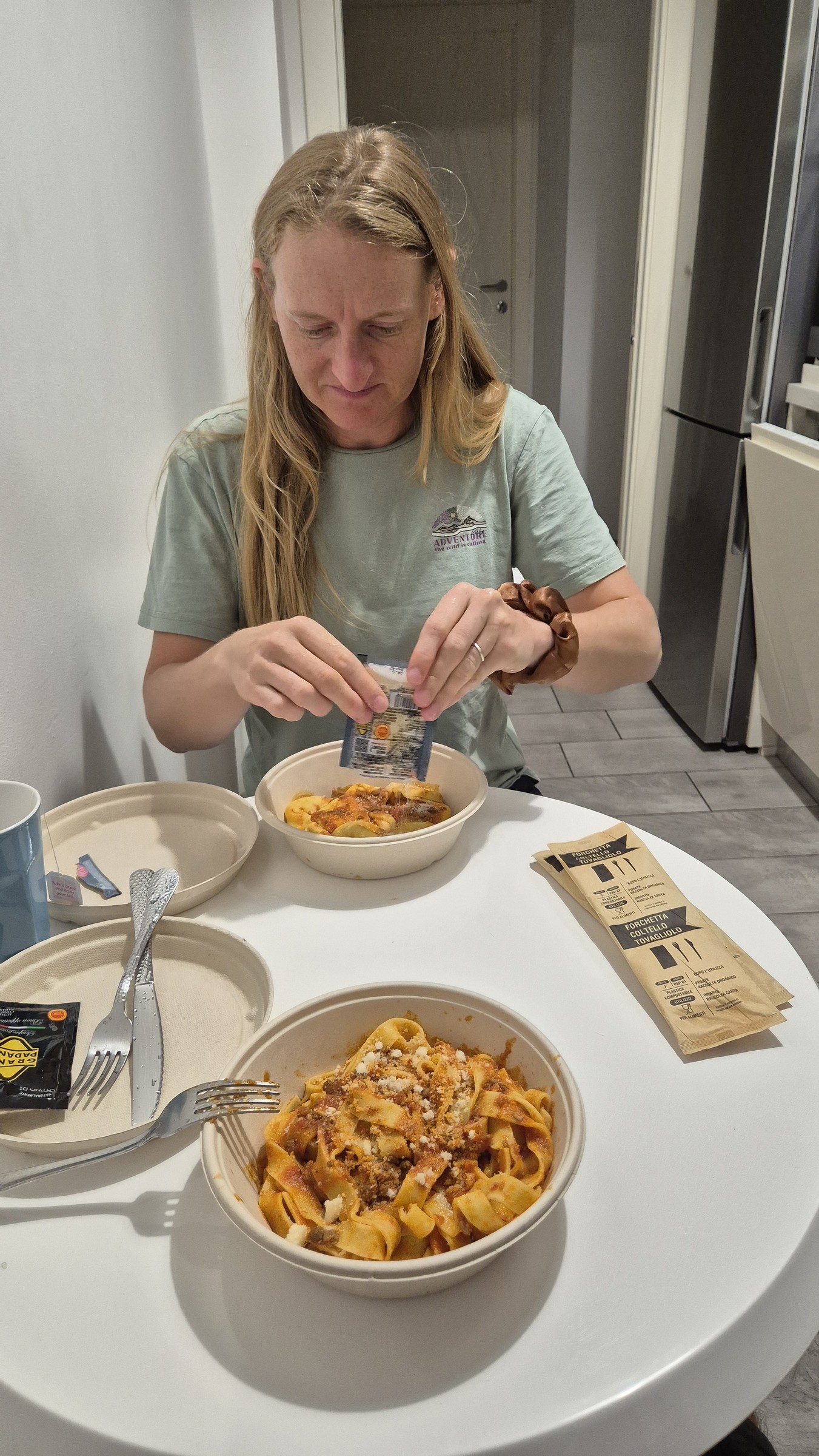 day67-caro-bologna-ragu-dinner Caro with two bowls of pasta with ragù after arriving in Bologna