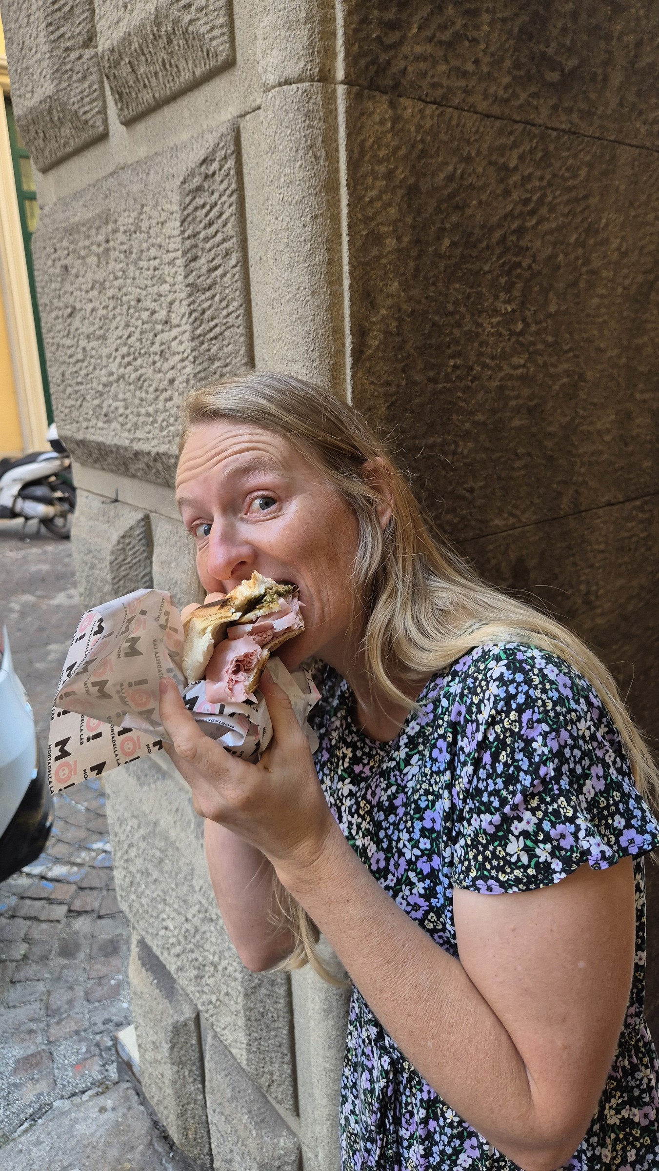 day68-caro-mortadella-sandwich Caro eating the first mortadella sandwich in Bologna