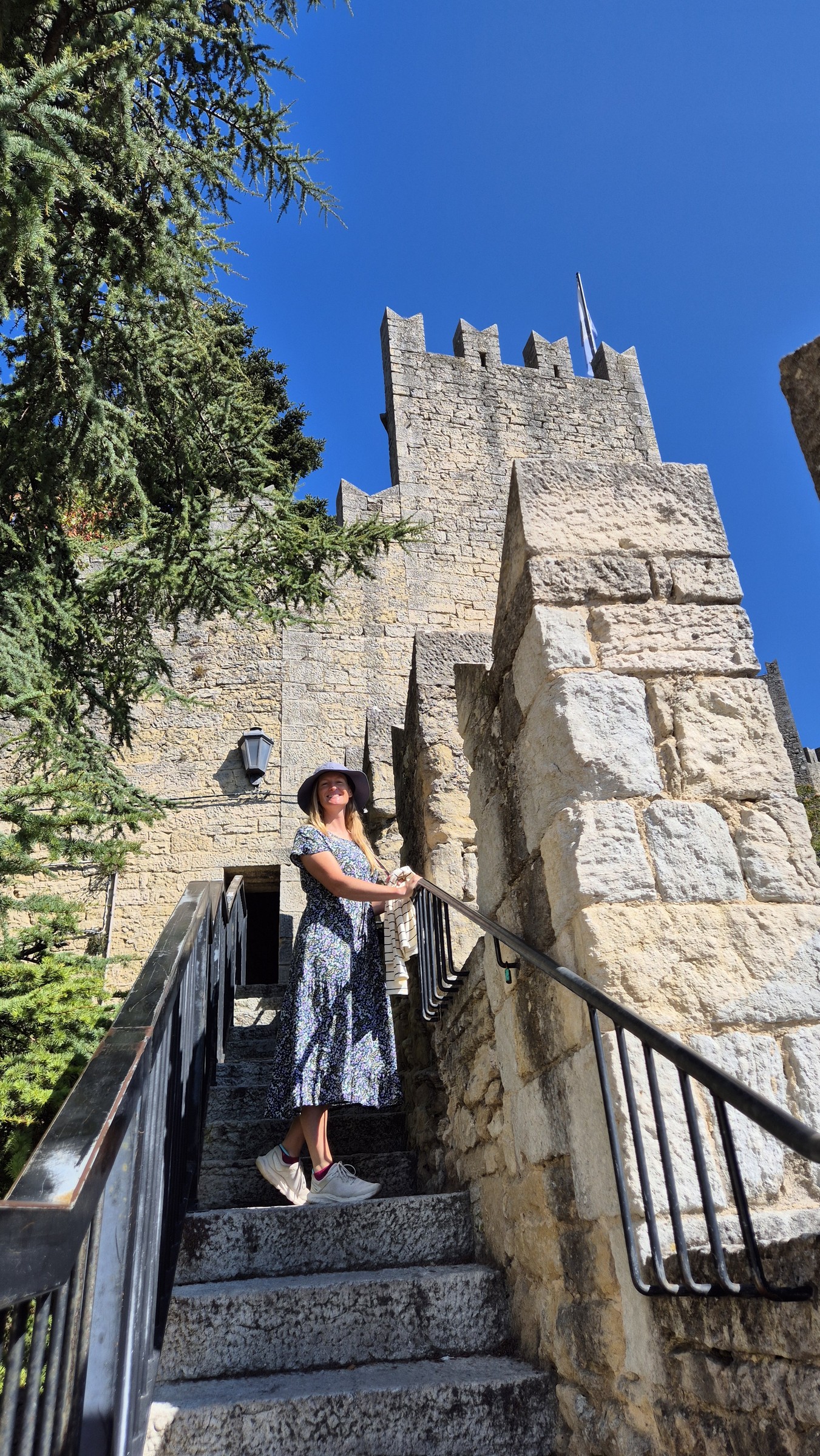 day69-san-marino-wall-stairs Caro climbing the narrow stone stairs beside San Marino's city wall