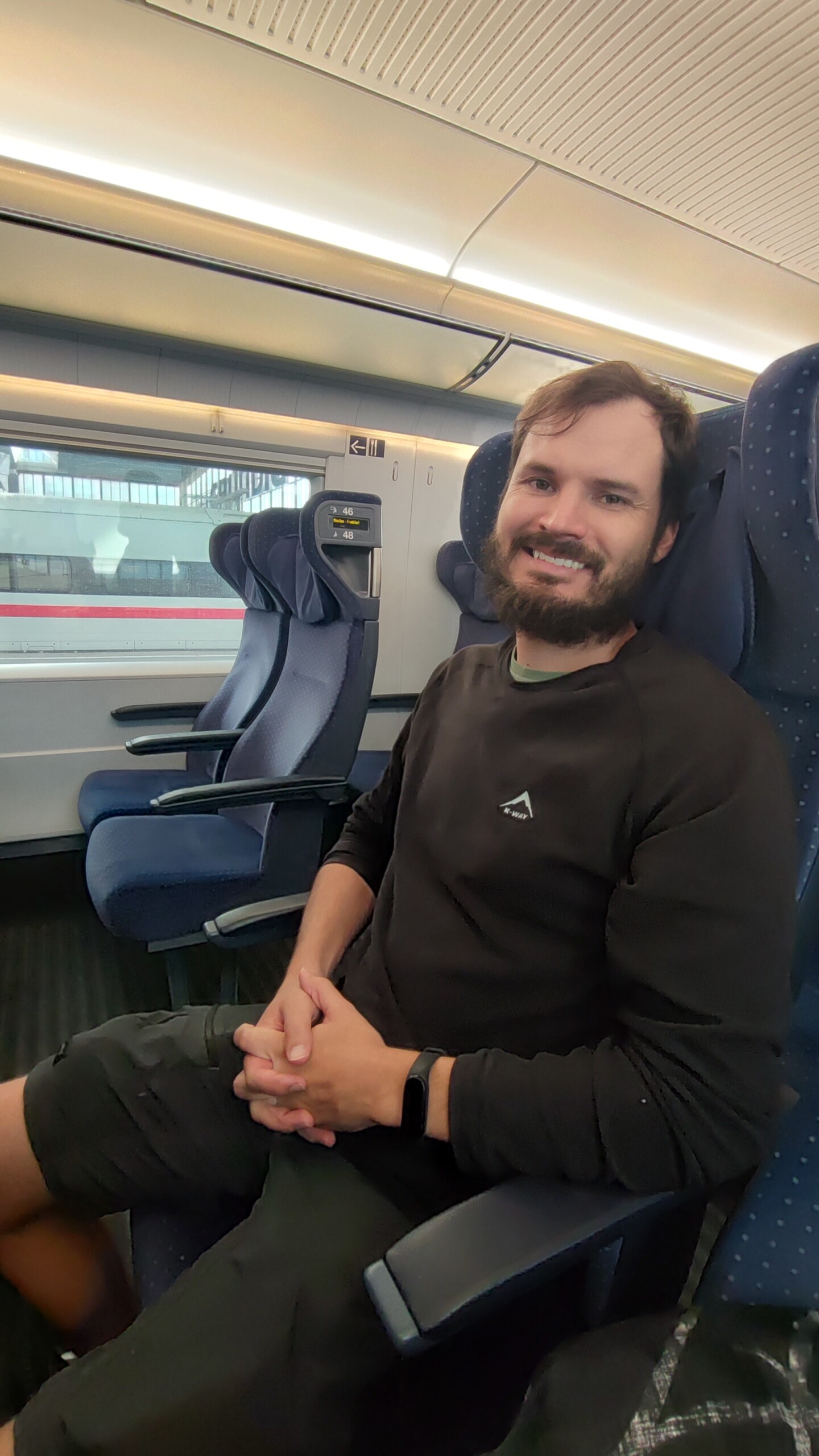 day71-hugo-train-seat Hugo seated on the train during the long journey to Frankfurt